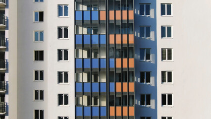 Close-up view facade of the beautiful colorful of a tall residential building. Motion. High-rise buildings modern architecture skyline.
