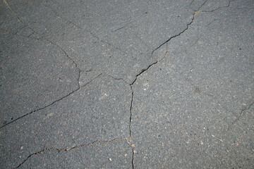 Obraz premium cracks on the paved highway, close up