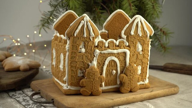 Gingerbread house Christmas homemade baking. Gingerbread Man. astle with white icing. Cookies in the shape of a Christmas tree and snowflakes on the table. Food for dessert. Winter gingerbread.