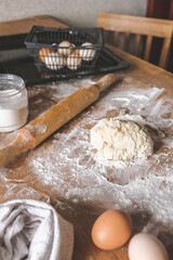 Girl prepares dough for bread.Homemade baking.Dough and hands close-up,ingredients for dough