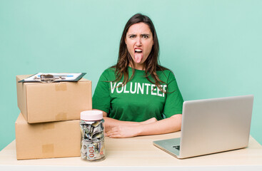 young pretty woman  feeling disgusted and irritated and tongue out. volunteer donation concept