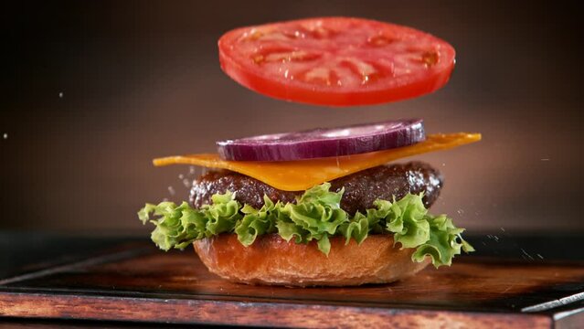 Beef Burger Ingredients Falling and Landing in the Bun. Super Slow Motion at 1000 fps.