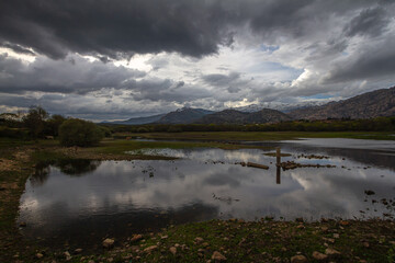 Long shot of a lake with mountains