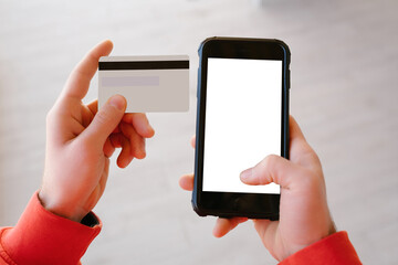 Online shopping, young man holding phone and credit card, waiting at a blank screen to fill in information