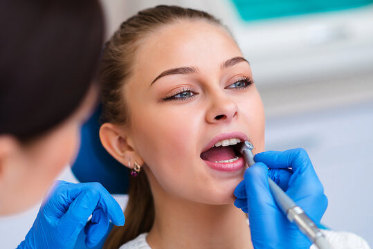 Doctor examining patient's teeth, closeup. Cosmetic dentistry.