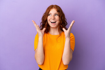 Teenager redhead girl over isolated purple background with surprise facial expression