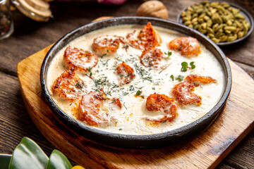 Cooked shrimp with creamy garlic sauce on table