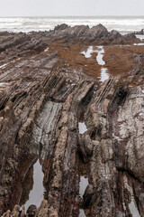 rocks on the beach of sopelana on the coast of the basque country a cloudy day