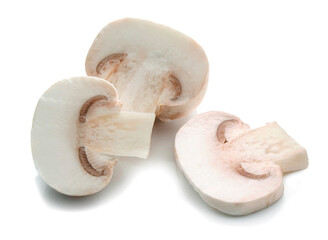 Fototapeta na wymiar three pieces of champignon mushrooms cut and placed on a white surface 