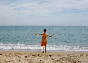 Girl in Orange on the Beach