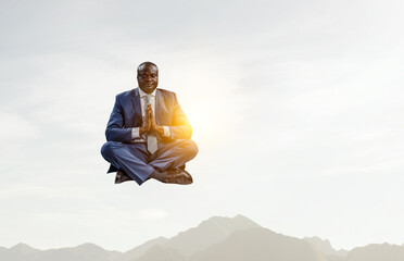 Young black man sitting and meditating