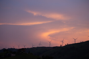 The viewpoint of Wind turbines generates electricity, wind turbines on a mountain top surrounded by...