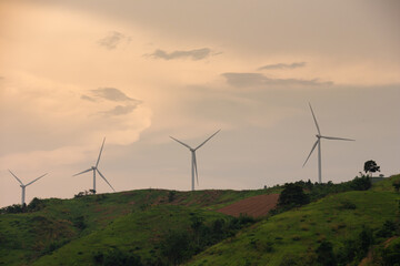 The viewpoint of Wind turbines generates electricity, wind turbines on a mountain top surrounded by...