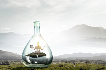Business woman doing yoga in lotus pose inside glass bottle