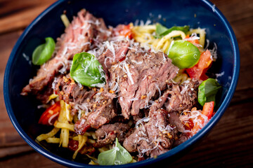 Grilled flank steak over basil pesto keto pasta