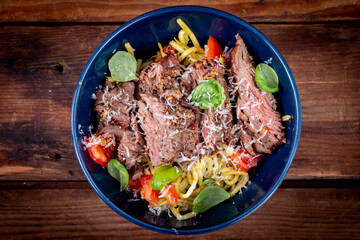 Grilled flank steak over basil pesto keto pasta