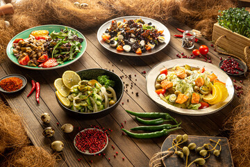 Variation of different georgian appetizers and salads on wooden table