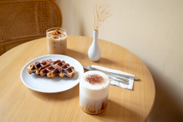 A Sunday morning meal in cafe, two cups of coffee, honey latte and Eispanner americano served with...