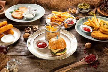 Variation of different fast food dishes on the wooden table