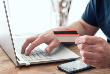 Fototapeta premium person using credit card and laptop computer for online shopping and payment, e-commerce concept