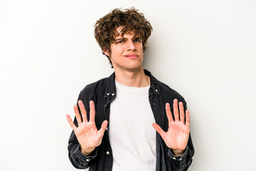 Young caucasian man isolated on white background rejecting someone showing a gesture of disgust.
