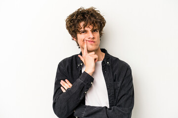 Young caucasian man isolated on white background unhappy looking in camera with sarcastic expression.
