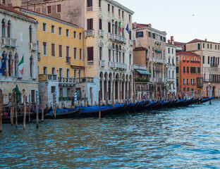 Fototapeta na wymiar The grand canal in venice in italy with cityscape view and gondolas lined up in the evening.