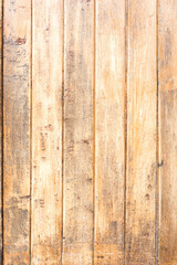 Texture of wood strips arranged vertically with weathered varnish.