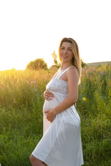 Fototapeta na wymiar mother to be. pregnancy portrait. beautiful brunette pregnant female expecting child. Happy future mother expecting a baby soon