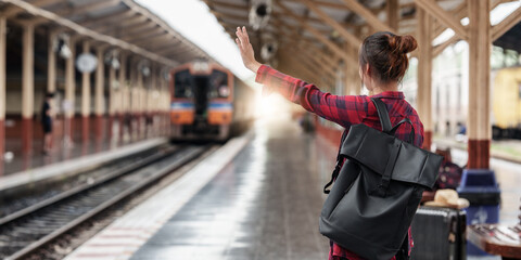 Pretty Young traveler woman planning trip at train station. Summer and travel lifestyle concept.