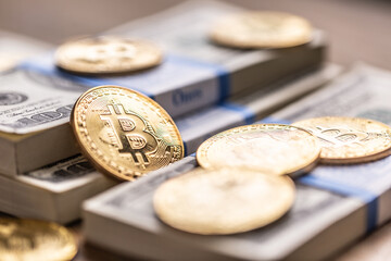 Gold Bitcoins on American Banknotes. Online trading between US currency and cryptocurrency.