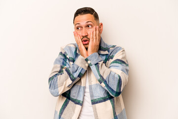 Fototapeta premium Young hispanic man isolated on white background scared and afraid.