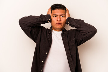 Young hispanic man isolated on white background being shocked, she has remembered important meeting.