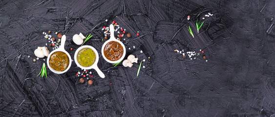 Sauces with spices on a black background