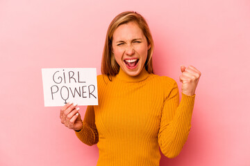 Young caucasian woman holding girl power placard isolated on pink background