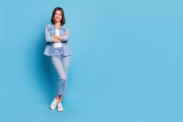 Photo of confident charming woman wear jeans shirt arms crossed smiling isolated blue color...