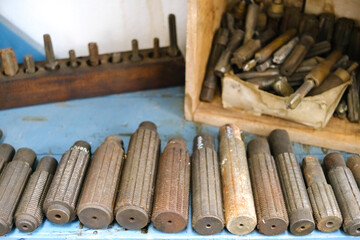 Metal chisels for working brass in an artisan factory of metal parts.