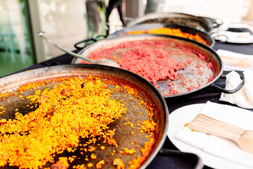 Variety of types of Valencian paellas with rice of different colors and flavors.