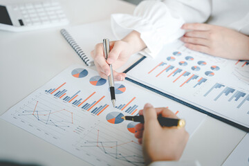 Teamwork with price chart analyzes business people on the table at the conference room.