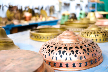 Different finished pieces of brass in a craft factory.