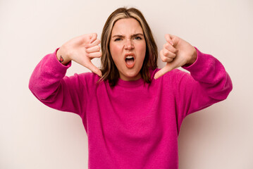 Young caucasian woman isolated on white background showing thumb down and expressing dislike.