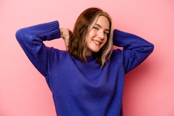 Young caucasian woman isolated on pink background stretching arms, relaxed position.