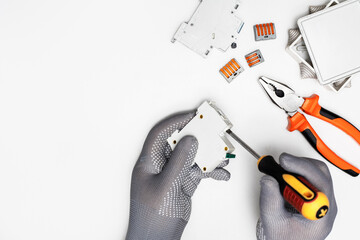 Man electrician working with electrical equipment. Repair concept with copy space.