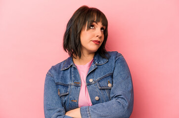 Young caucasian woman isolated on pink background dreaming of achieving goals and purposes