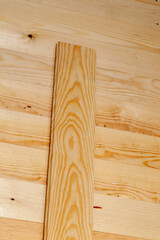 yellow-orange pine wood board during construction works,
