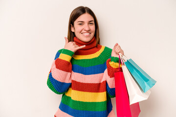 Young caucasian woman going to shopping isolated on white background showing a mobile phone call gesture with fingers.