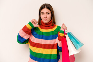 Young caucasian woman going to shopping isolated on white background showing a dislike gesture, thumbs down. Disagreement concept.