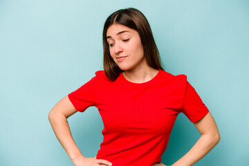 Young caucasian woman isolated on blue background dreaming of achieving goals and purposes