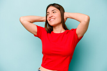 Young caucasian woman isolated on blue background feeling confident, with hands behind the head.