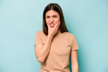 Young caucasian woman isolated on blue background having a strong teeth pain, molar ache.